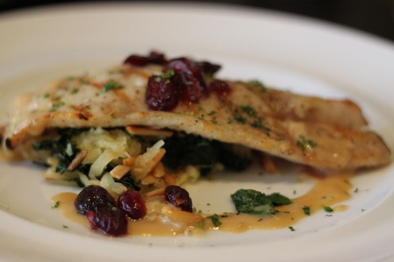 Though Marlow's has a tavern atmosphere, dishes such as Grilled Trigger Fish (with spaghetti squash, kale, toasted almond, brandied Craisins, sage cider cream) show a chef's touch. (Courtesy of Marlow’s Tavern)