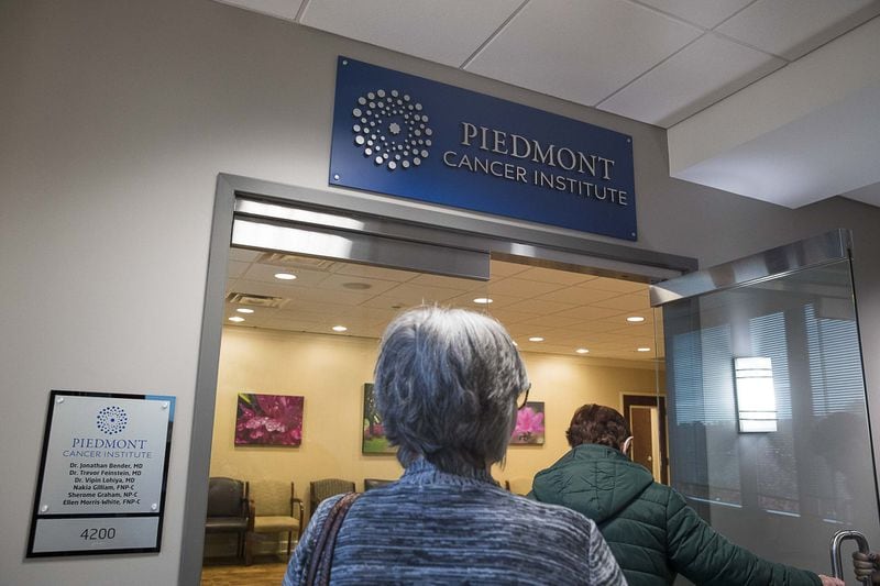 American Cancer Society’s Road To Recovery program driver Melissa Staton (left), 66, and Linda Wayman (right), 74, enter the Piedmont Cancer Institute inside Piedmont Fayette Hospital. (Alyssa Pointer/Atlanta Journal Constitution)