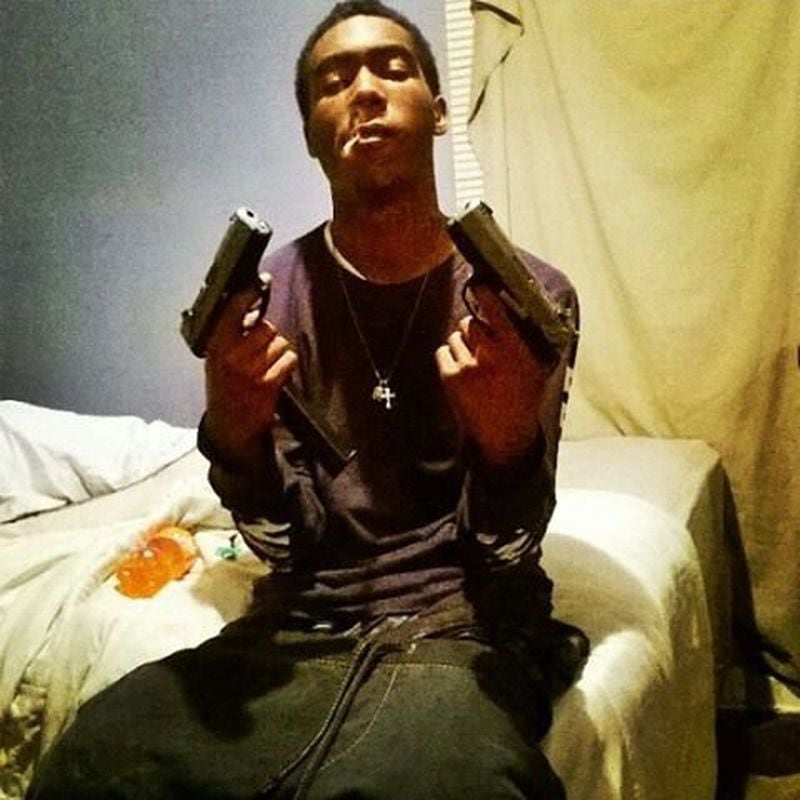 Oliver Campbell Jr., known to friends and family as "Poopoo" and known as "Plug" in the rap group OneFive 1K, is shown with two handguns. He was killed July 30, 2015, in what prosecutors say was a gang-related crime. This photo is taken from a friend's public Instagram page.