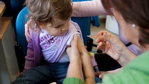 A child receives a flu shot. A new CDC study finds vaccines help prevent  flu deaths among children.