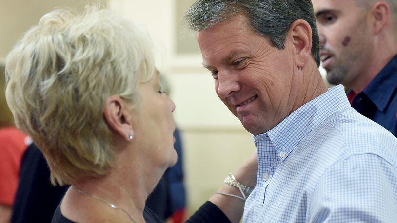 GOP candidate for governor Brian Kemp (right) chats with supporter at the Ocilla, Ga., Community House earlier this month. RYON HORNE / RHORNE@AJC.COM