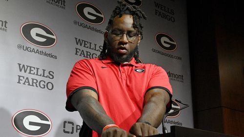Georgia defensive lineman Zion Logue shows off his College Football Playoff national championship trophy tattoo on his right arm during a press conference at the Butts-Mehre building ahead of spring practice, March 14, 2023, in Athens, GA. (Hyosub Shin / Hyosub.Shin@ajc.com)