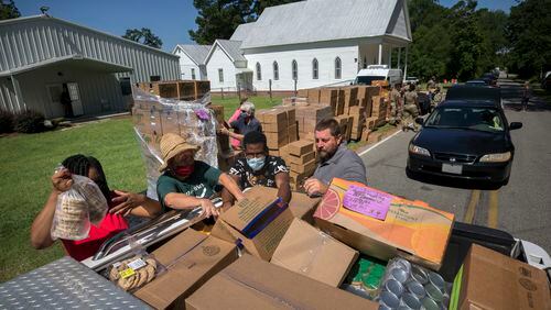 SUMMERTOWN, GA - JULY 14, 2020: Volunteers with the Summertown Food Pantry load bed of a pickup truck with items during the mobile food drive at the Summertown Baptist Church. Members of the pantry will deliver this load to rural poor who can not make it to the food drive. (AJC Photo/Stephen B. Morton)