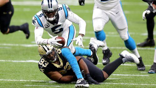Carolina Panthers quarterback Teddy Bridgewater (5) runs with the ball while being tackled by the New Orleans Saints' David Onyemata (93) in the first quarter at the Mercedes-Benz Superdome in New Orleans on Sunday, Oct. 25, 2020. (Jonathan Bachman/Getty Images/TNS)