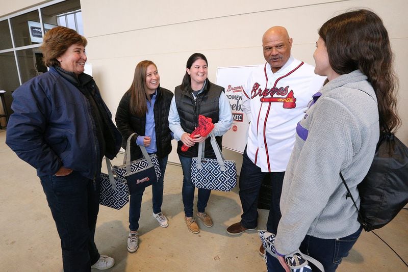 Dr. Mary Boden (from left) and her triplet daughters Stephanie, Allison and Lauren shared a laugh while they met former Braves player Chris Chambliss at the Braves Women’s Baseball Clinic at SunTrust Park before the Braves played the Yankees in a preseason game last month. CURTIS COMPTON / CCOMPTON@AJC.COM