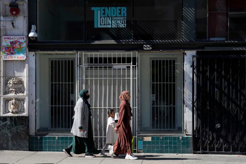 People walk in the Tenderloin neighborhood Saturday, April 20, 2024, in San Francisco. (AP Photo/Godofredo A. Vásquez)