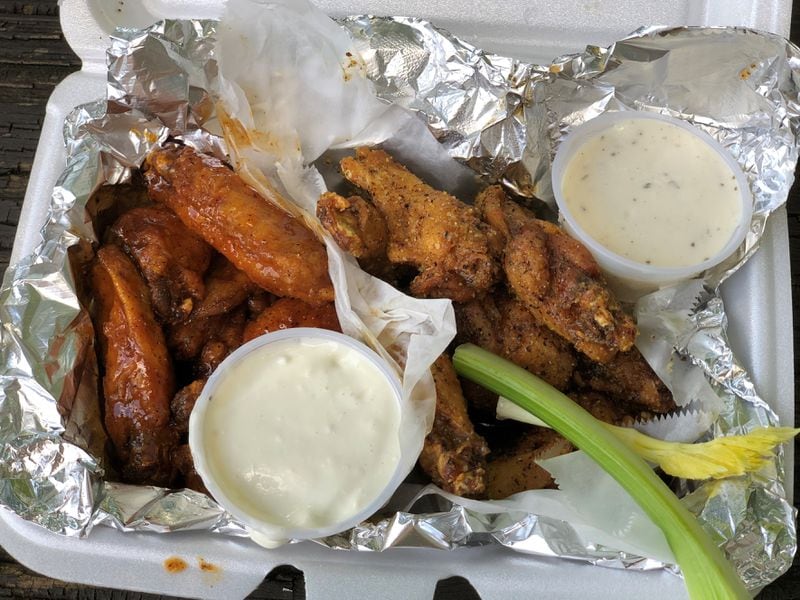 An order of 10 wings from Taco Pete Bistro in Hapeville: five with house sauce (tangy-sweet with a hint of curry) and five with lemon-pepper. 
Wendell Brock for The Atlanta Journal-Constitution