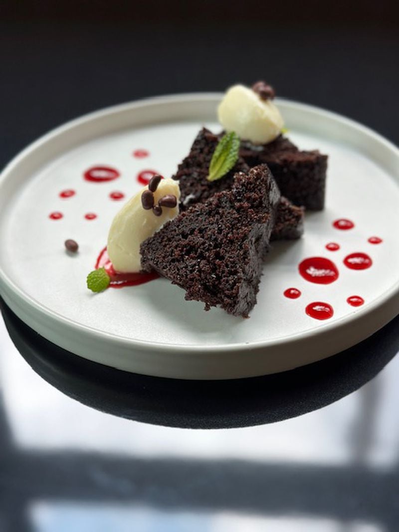 Raspberry beet sauce is an elegant enhancement to the moist chocolate cake with white chocolate cream cheese frosting at Southern National. Courtesy of Rebecca Carmen