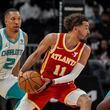 Atlanta Hawks guard Trae Young (11) moves the ball against the Charlotte Hornets during the first half of an NBA basketball game, Wednesday, April 10, 2024, in Atlanta. Charlotte won 115-114. (AP Photo/Mike Stewart)
