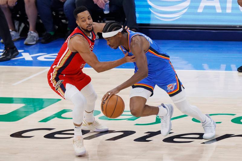 Oklahoma City Thunder guard Shai Gilgeous-Alexander, right, drives against New Orleans Pelicans guard CJ McCollum, left, during the first half in Game 2 of an NBA basketball first-round playoff series, Wednesday, April 24, 2024, in Oklahoma City. (AP Photo/Nate Billings)
