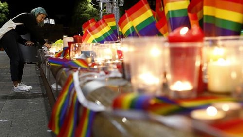 SYDNEY, AUSTRALIA - JUNE 13:  A woman lights a candle during a candlelight vigil for the victims of the Pulse Nightclub shooting in Orlando, Florida, at Oxford St on June 13, 2016 in Sydney, Australia. 50 people were killed and 53 injured after a gunman opened fire on people in a gay nightclub in Florida. It is the deadliest mass shooting in US history.  (Photo by Daniel Munoz/Getty Images)