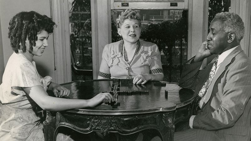 Josephine and George Schuyler play dominoes at home with their daugther Philippa in the mid-1940s. (Schomberg Center for Research in Black Culture/New York Public Library)