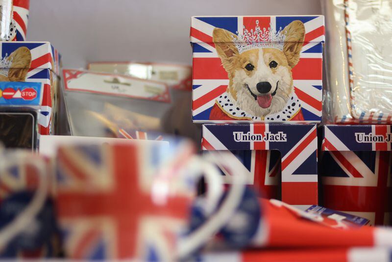 A corgi wearing a crown, evoking one of the queen's beloved pets, adorns a box at the Taste of Britain shop in Norcross. The queen's reign spanned 14 U.S. presidencies and 15 British prime ministers. (Jason Getz / Jason.Getz@ajc.com)