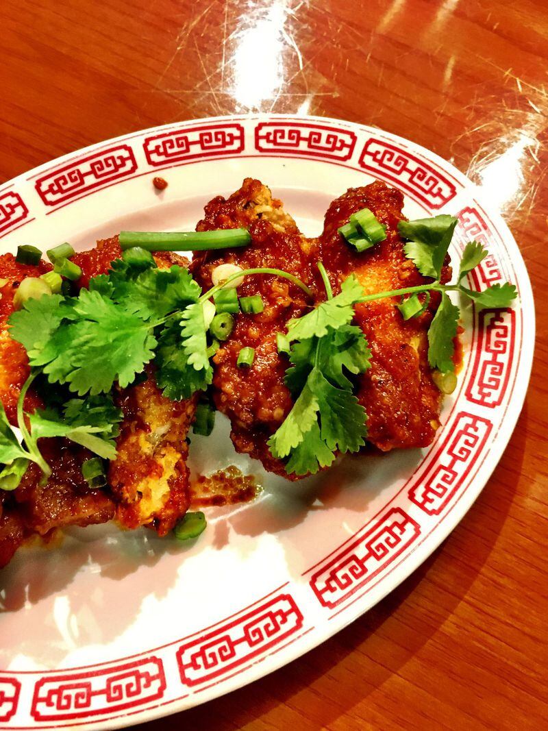 Chongqing chicken wings are garnished with cilantro and scallions. CONTRIBUTED BY WYATT WILLIAMS