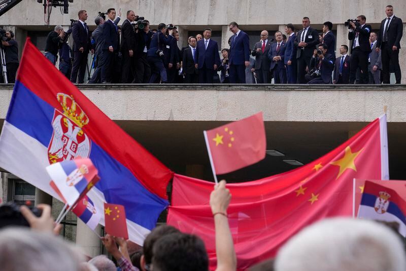 Chinese President Xi Jinping, centre left, and his Serbian counterpart Aleksandar Vucic, center right, greet the crowd as they arrive at the Serbia Palace in Belgrade, Serbia, Wednesday, May 8, 2024. (AP Photo/Darko Bandic)